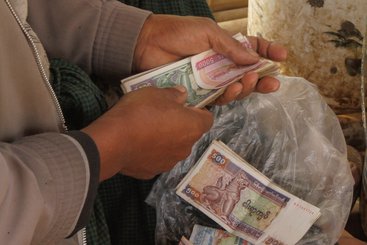 The Government of Myanmar allowing for a managed float of the kyat, legalising the use/exchange of foreign currencies 
